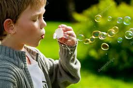 boy blowing bubbles